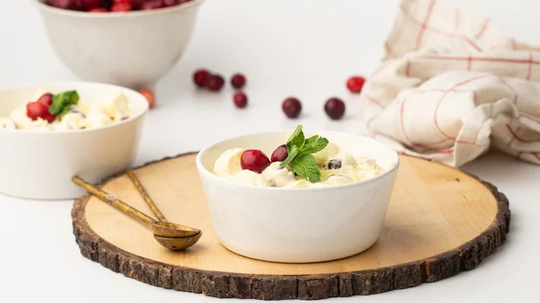 Bowls of whipped cream with cranberries