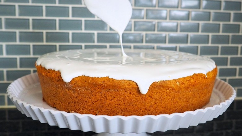 Round pumpkin cake frosted with marshmallow topping