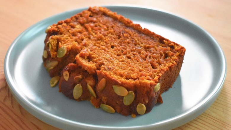 Pumpkin bread slice with pepitas on a plate