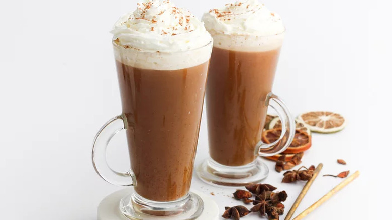 Tall glass mugs of spiced coffee with whipped cream