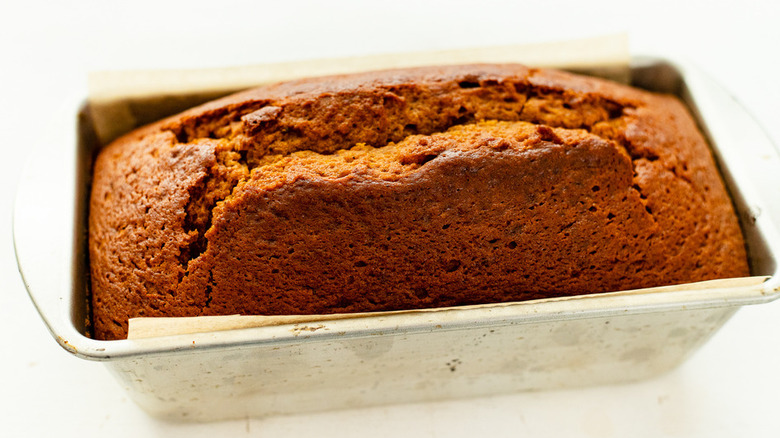 Baked loaf of pumpkin bread in a tin