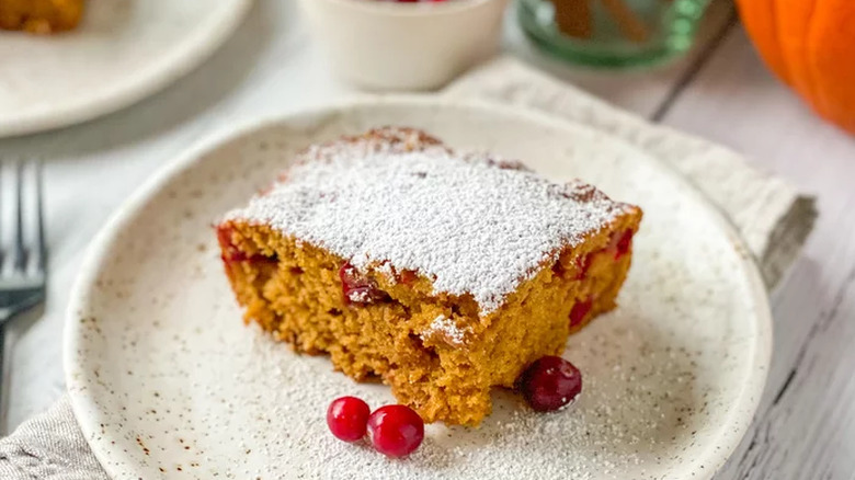 Pumpkin cake slice with cranberries on plate