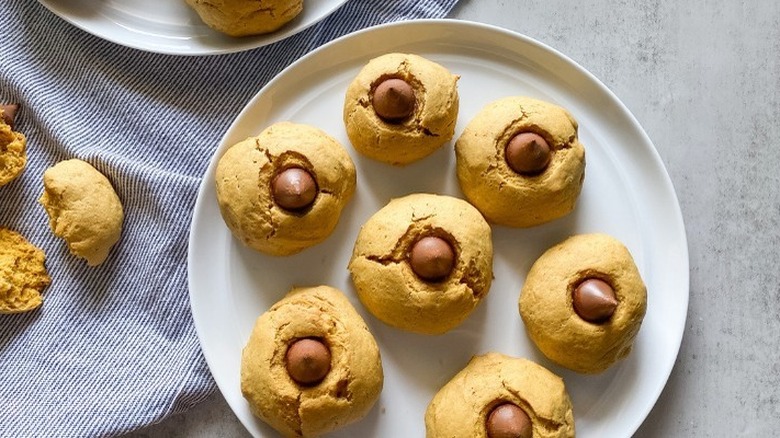 Plate of round cookies with chocolate kisses in centers