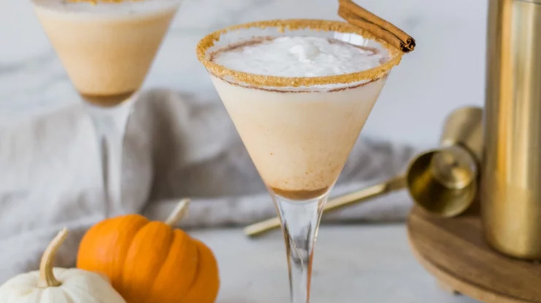 Cocktail glass with cinnamon rim and creamy drink.