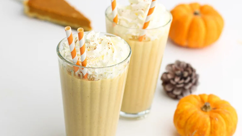 Pumpkin milkshakes in glasses withs straws