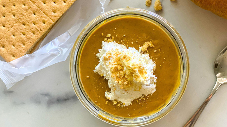 Glass dish of orange pudding and cream