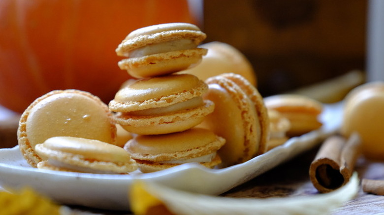 Stack of orange macaron cookies with white filling