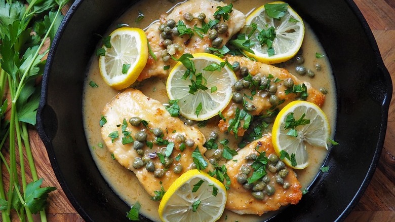 Chicken, lemons and capers in a skillet