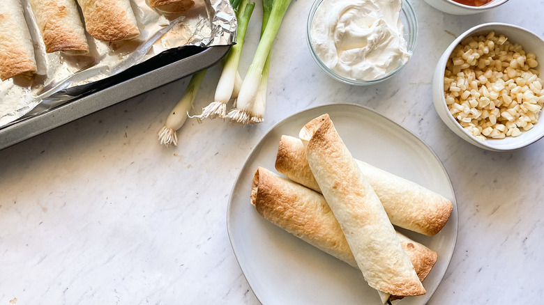 Browned taquitos with corn and scallions