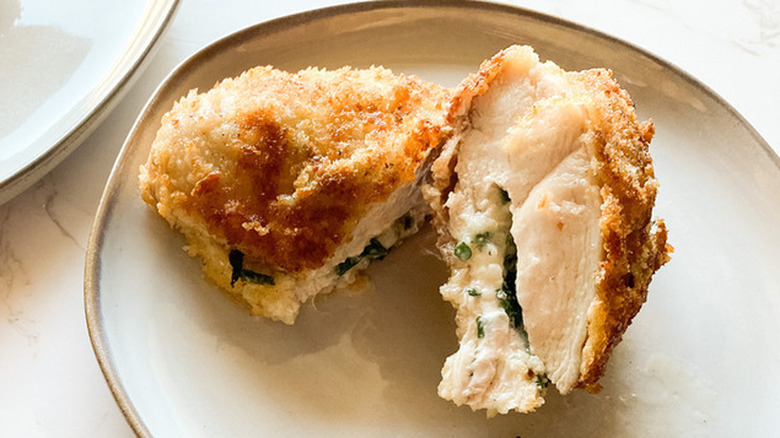 Breaded stuffed chicken breast on a plate