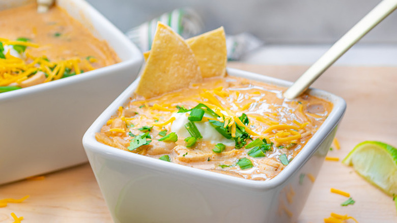 White bowl of chicken chili and chips