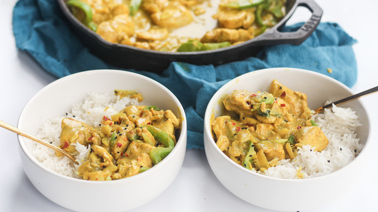 Rice and curry chicken in white bowls