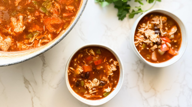 Small bowls of chicken and tomato soup