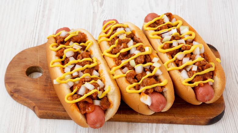 Chili dogs on wooden board