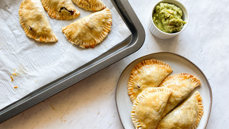 Empanadas on tray and plate