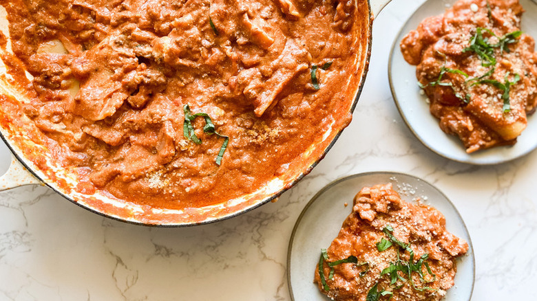 Skillet and plates with lasagna