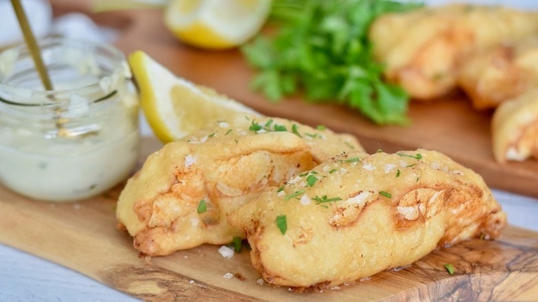 fried fish on wooden board