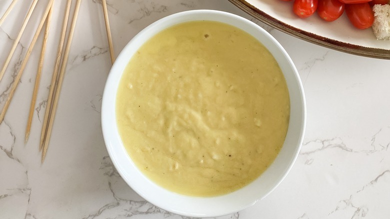 cheese fondue in white bowl
