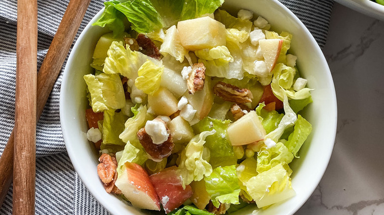 Romaine salad with apples, cheese, and nuts.