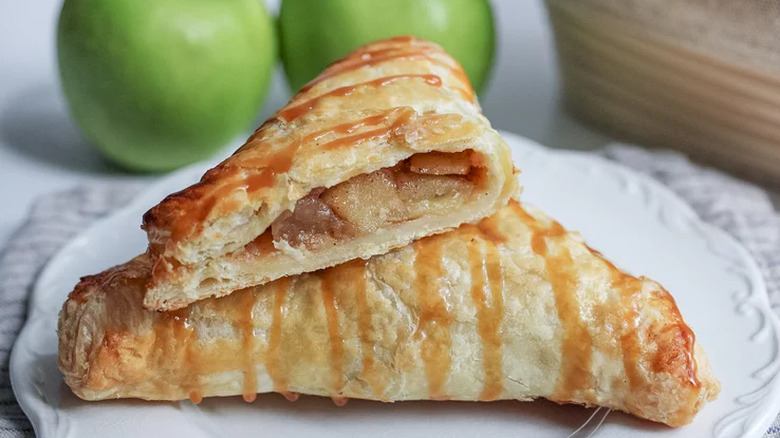Pastry pockets with apple filling and caramel drizzle.
