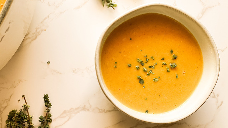 orange squash soup with herbs.