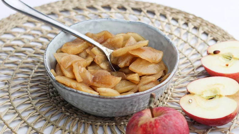 Bowl of cooked, brown sugar apple slices.