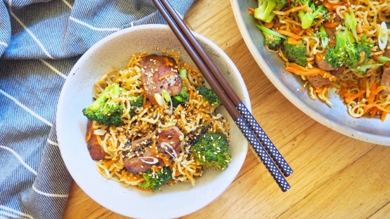 bowls of lo mein with chopsticks