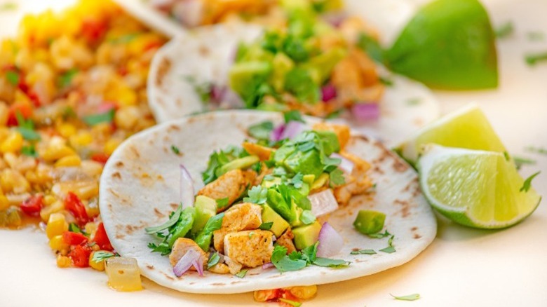 chicken tacos with lime wedges