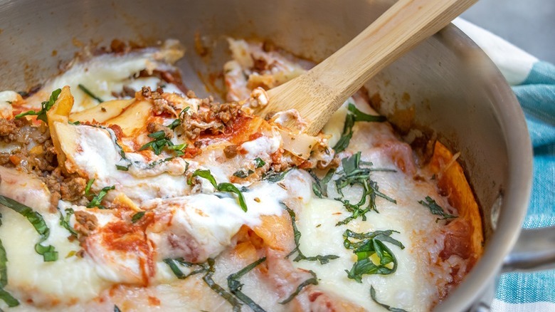 pan of lasagna with wooden spoon