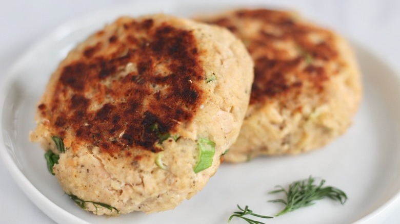 two salmon patties with garnish