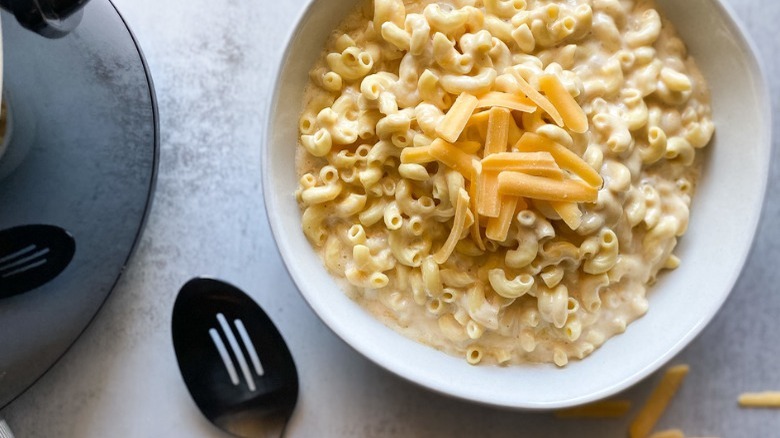 mac and cheese with slotted spoon