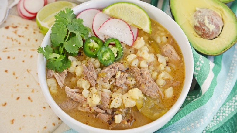 bowl of pozole with avocado