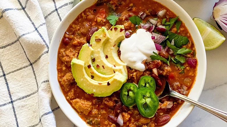 Chili with avocado and jalapenos and sour cream