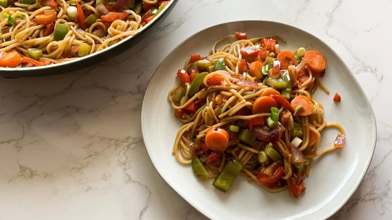 plate and pan of vegetable lo mein