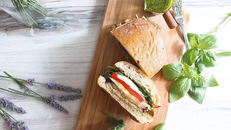 wooden cutting board with grilled vegetable sandwiches
