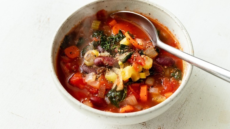 bowl of minestrone soup with spoon