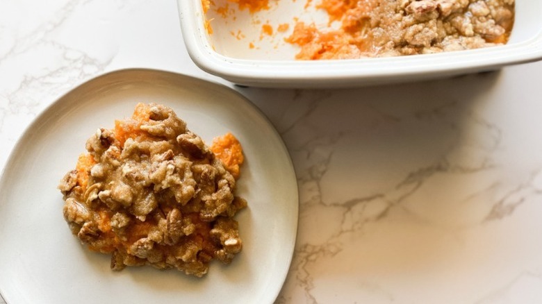 plate and casserole dish of sweet potato casserole