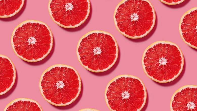 grapefruit slices on pink background