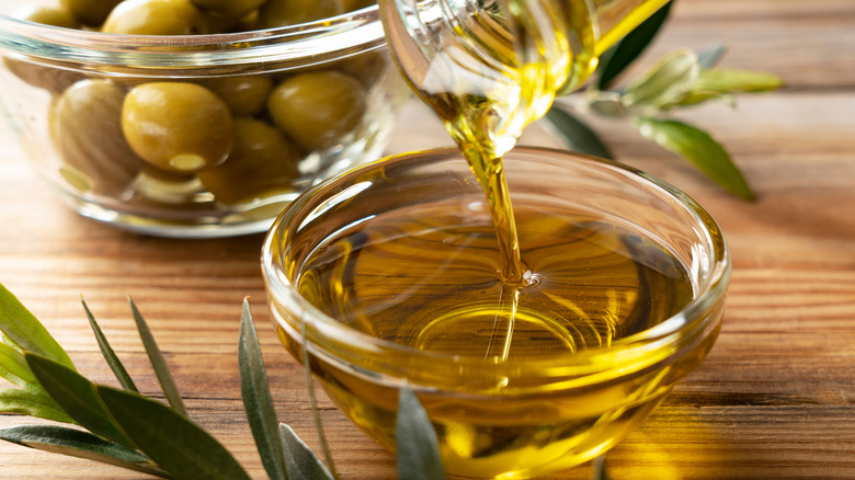 pouring olive oil into bowl