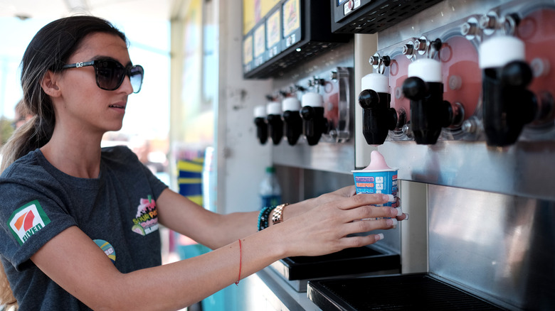 7-Eleven employee pouring a Slurpee