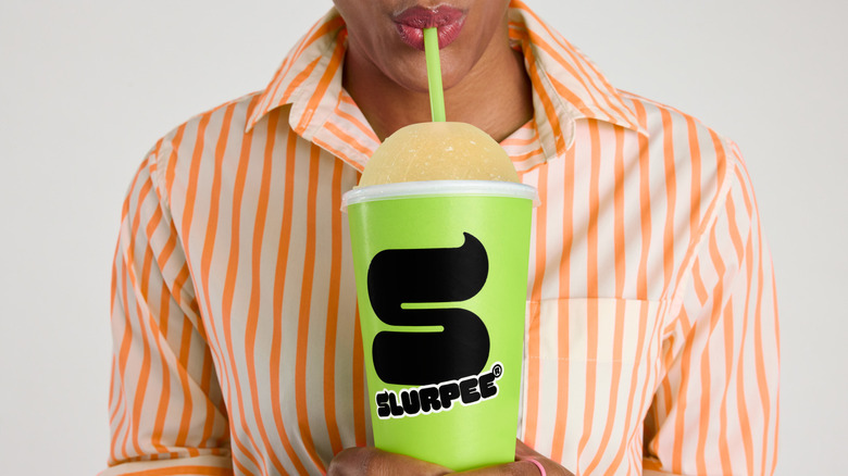 Person drinking Slurpee with straw