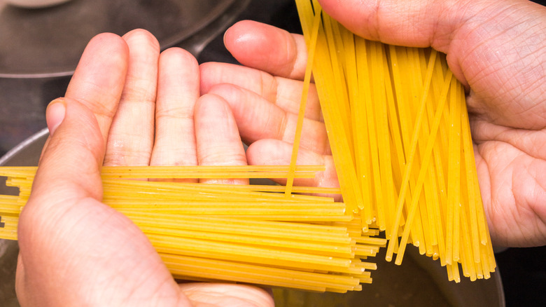 holding broken noodles