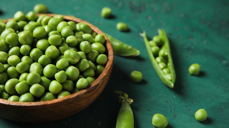 green peas pod wooden bowl