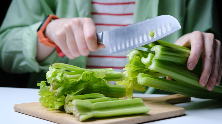 person cutting celery knife