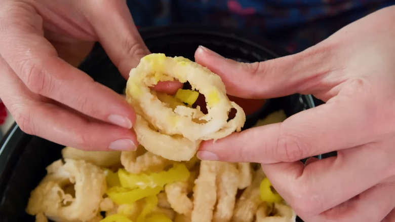 Person holding calamari and peppers