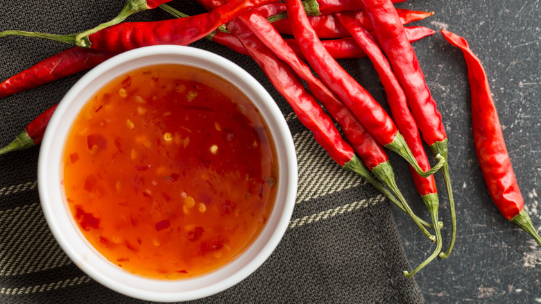 Small bowl of sweet chili sauce with red peppers