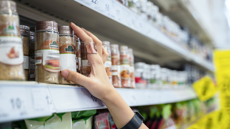 Hand reaching for item on shelf