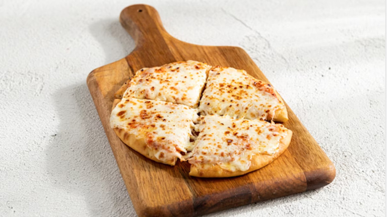 Chili's cheese pizza on cutting board