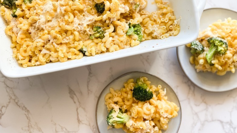 pan and bowls of broccoli mac and cheese