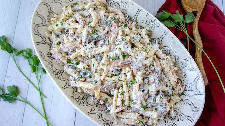 bowl of creamy crab pasta salad and wooden spoon